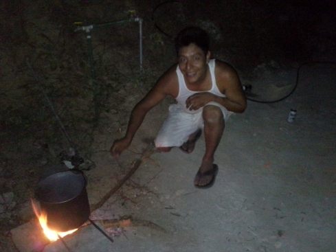 Uriel stoking the fire so our black beans cook. Our albanil, our sobrino, our friend. 